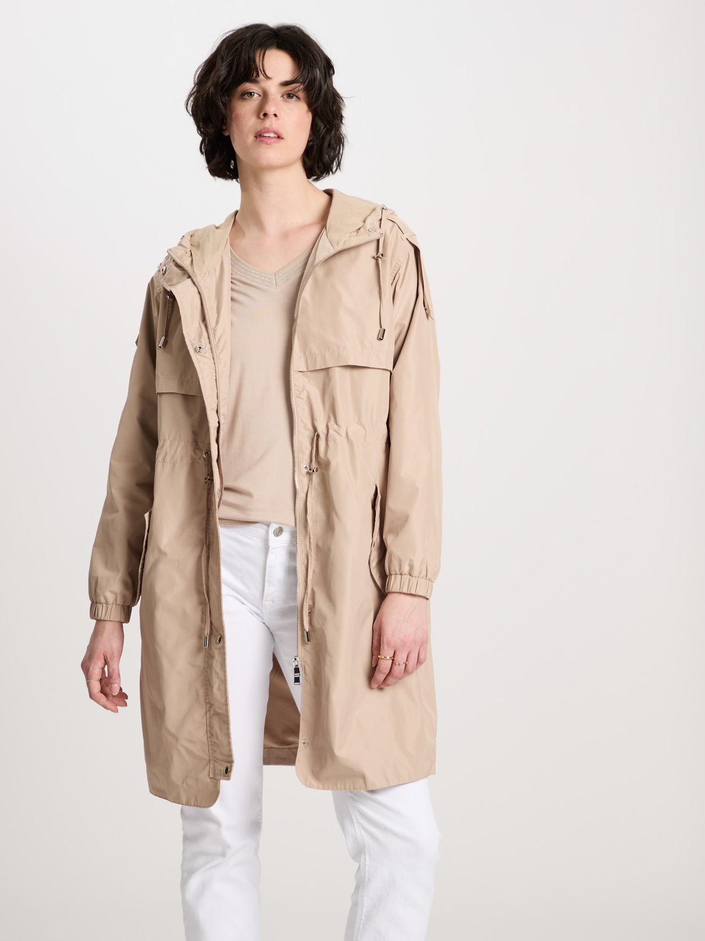 Women's regular coat with hood, zip and snap fasteners in beige.