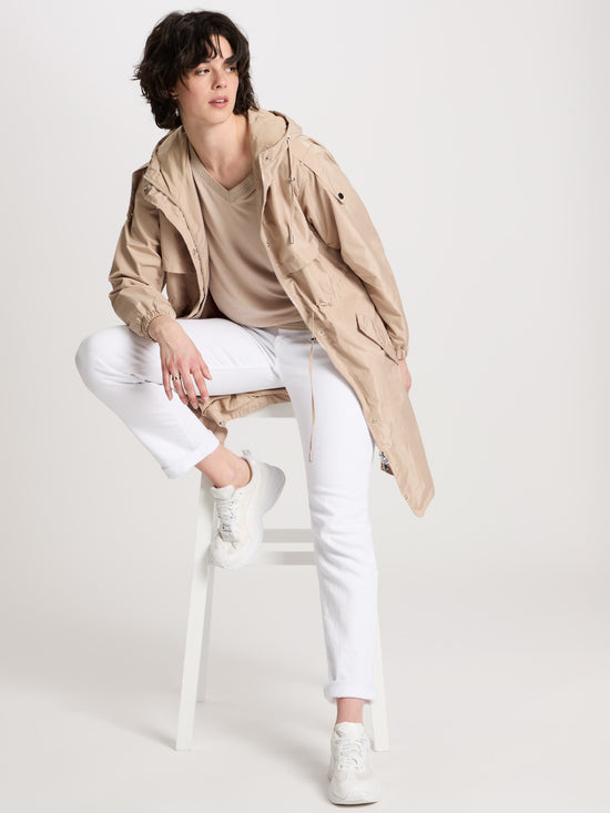 Women's regular coat with hood, zip and snap fasteners in beige.